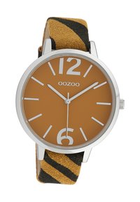 Round silver watch with a brown face, white hour markers, and a fabric strap featuring yellow and black stripes.