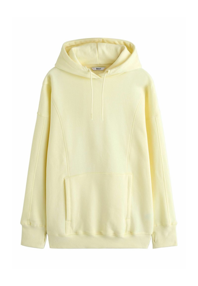 Gele hoodie gemaakt van zacht materiaal met een voorzak, capuchon met trekkoord en een losse pasvorm. Voorzien van geribbelde boorden bij de mouwen en zoom.