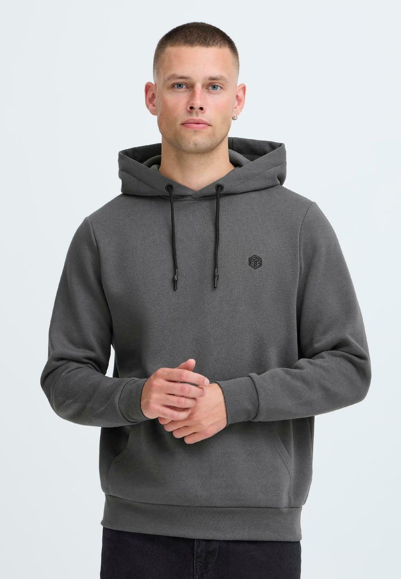Gray hooded sweatshirt made of soft fabric. Features a drawstring hood, front pocket, and small logo on the chest. Fitted cuffs.