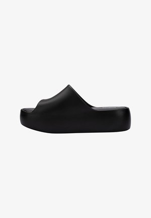 Black slide sandal with a smooth, matte finish. Features an open toe design and a thick, rounded sole. Simple and minimalist shape.