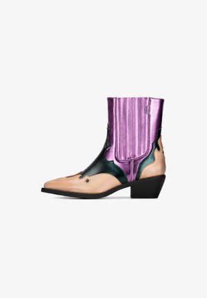 Westerse enkellaars in zwart, metallic paars en huidskleur. Kenmerken zijn de spitse neus, blokhak, decoratieve uitsparingen en verticale geribbelde accenten.