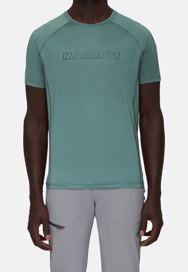Light green short-sleeve T-shirt with a rounded neckline, featuring a bold "MAMMUT" logo printed across the chest and contrasting stitching.
