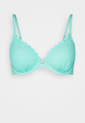 Svetlo tyrkysová podprsenka so zvlnenými okrajmi, jemný materiál, nastaviteľné ramienka a nahrnuté košíčky. Obsahuje háčikový uzáver na zadnej strane.