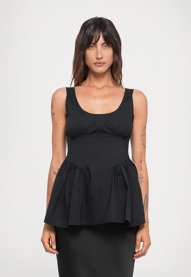 Black peplum top made of fabric with a smooth texture, featuring a scoop neckline and gathered bodice, flaring out at the waist.