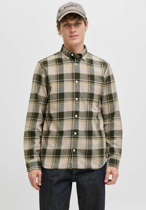 Groene en beige geruite shirt met lange mouwen en een knoopsluiting; beschikt over kleine knopen en een ontspannen pasvorm. Draagt men met donkere jeans.