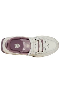 Zapatillas blancas y lavanda con una parte superior texturizada, puntera redonda, cuello acolchado y cordones planos con logotipo en la lengüeta.