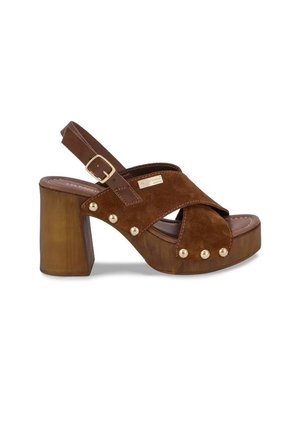Brown suede platform sandal with chunky wooden heel, crisscross straps, gold studs, and adjustable buckle slingback strap.