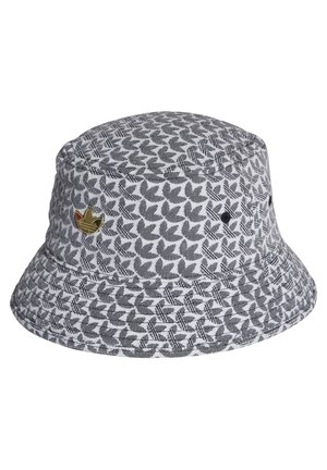 Szara i biała czapka typu bucket z czarnymi, liściastymi wzorami oraz małą złotą naszywką z boku.