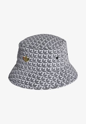 Szara i biała czapka typu bucket z czarnymi, liściastymi wzorami oraz małą złotą naszywką z boku.