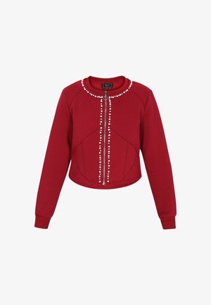 Felpa corta rossa in tessuto morbido con zip frontale, decorata con un motivo perlaceo lungo il colletto e la cucitura centrale.