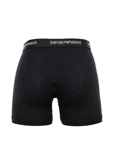 Boxers noirs pour hommes avec logo Emporio Armani et emblème d'aigle sur la ceinture élastique, vus de dos.