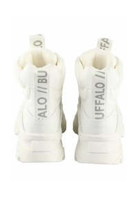 White high-top sneakers with textured fabric, prominent tabs, and a thick sole. Features logo print in gray on the heel and side panels.
