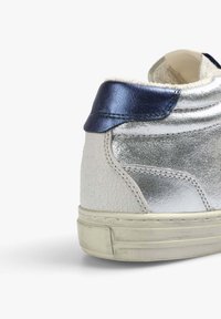 Wysokie sneakersy z metalicznej srebrnej skóry, textured białej skóry oraz granatowego skórzanego kaptura na pięcie. Guma podeszwy z subtelnymi śladami zużycia.