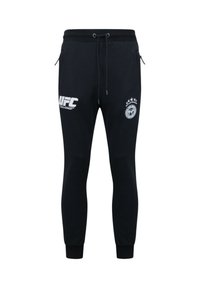 Zwarte joggingbroek met een trekkoord in de taille, voorzien van het UFC-logo en een cirkelvormig embleem met sterren aan de zijkant. Aansluitende boorden. Glad stof.