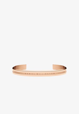 Rožinio aukso apyrankė su matinį paviršiumi, turinti dvi lygiagrečias juostas ir išgraviruotą užrašą "DANIEL WELLINGTON" vienoje pusėje.