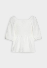 Blusa bianca con scollo quadrato, maniche a sbuffo e motivo floreale tessuto. Orlo svasato con dettagli arricciati. Realizzata in tessuto leggero.