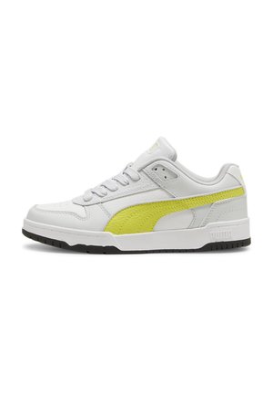 White sneakers with a textured leather finish, featuring a bold yellow accent on the side and grey laces. Black rubber sole. Minimalist design.