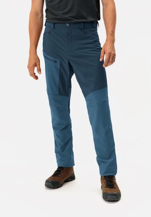 Men's blue outdoor pants made of flexible fabric, featuring zippered pockets, a slim fit, and contrasting panels in the knee area.