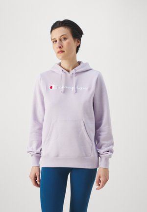 Sudadera ligera de color púrpura con capucha ajustable, bolsillo frontal y logo bordado. Tejido suave, puños acanalados y detalle del logo distintivo en la manga.