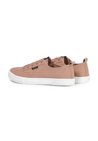 Pair of light brown canvas sneakers with white rubber soles and laces, back pull-tabs, and small black brand label on the side.