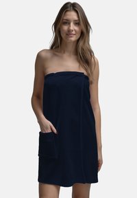 Wrap in spugna di colore navy realizzato in tessuto morbido, caratterizzato da un design senza spalline, tasca frontale e una texture liscia. Adatto per l'uso dopo la doccia.