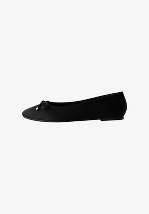 Black flat ballet shoe with rounded toe, small decorative bow on front, and low heel, shown from a side view on white background.
