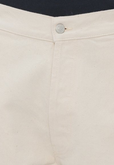 Beige cotton trousers with a subtle twill texture, featuring a metal button closure and standard stitching along the seams.