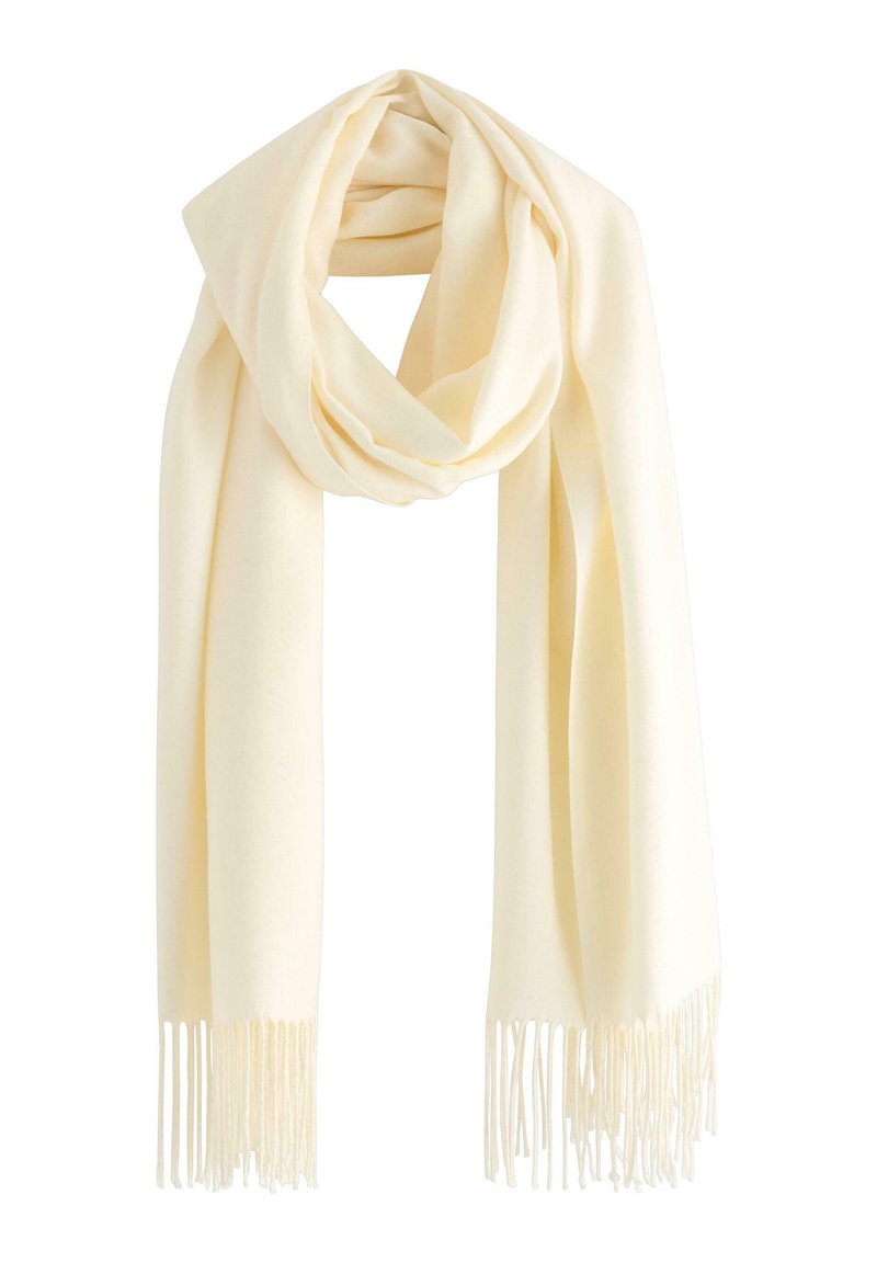 Kremowy szalik wykonany z miękkiego materiału, charakteryzujący się gładką teksturą i długimi frędzlami po obu końcach. Ułożony w pętlę.