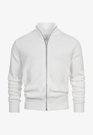 Fehér cipzáras kardigán, textúrált mintával, bordás mandzsettákkal és magas gallérral, kontrasztos cipzárral. Puha kötött anyag.