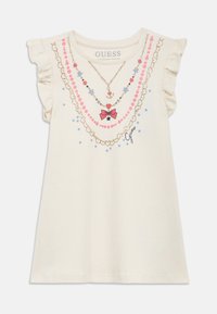 Tricou de culoare crem cu mâneci cu volane, având imprimeuri colorate în formă de coliere, inclusiv o fundă roz și stele albastre.