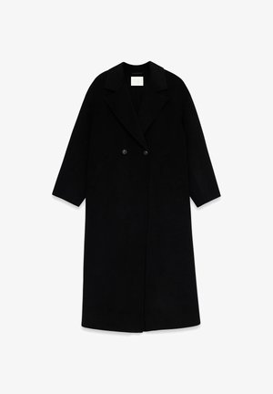 Pikk must mantel, valmistatud pehmest kangast, kahe-rea nööpidega, sälguga krae, küljetaskute ja lõdva istuvusega.