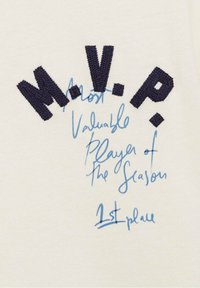 Tessuto crema con lettere ricamate in navy "M.V.P." e testo scritto a mano in azzurro "Miglior Giocatore della Stagione. 1° posto."