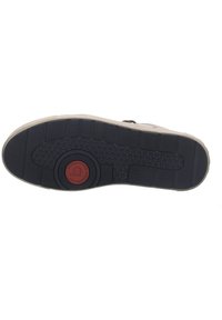 Suola della scarpa con un fondo in gomma nera caratterizzato da un motivo a trama testurizzata e un logo circolare rosso centrale, bordato da una suola intermedia beige.