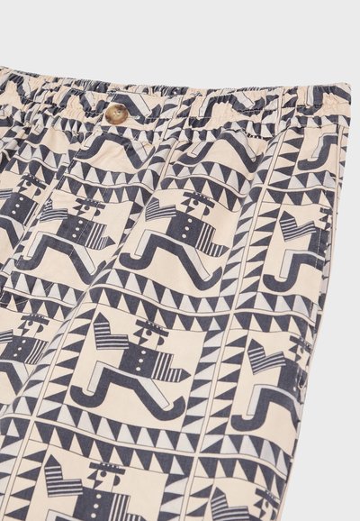 Katoenen shorts met een geometrisch patroon van gestileerde figuren in marineblauw en roomkleur. Elastische tailleband met een knoopdetail.