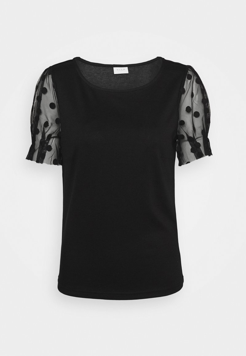 Haut noir à manches courtes avec manches bouffantes transparentes avec des pois en relief et un col rond.