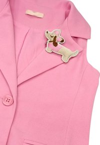 Blazer rosa con tessuto texturizzato, chiusura a pulsante singolo e una spilla ricamata a forma di cane con accenti rosa e marroni.