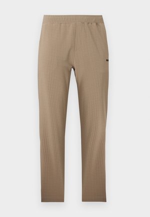 Beige textured leggings with high elastic waistband, slim fit, and subtle brand logo on the right thigh.