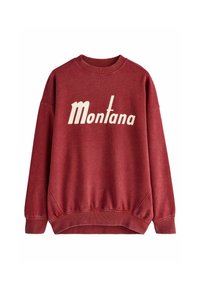 Crvena pamučna dukserica s rebrastim izrezom i manžetama. Ima bijeli natpis "Montana" u retro fontu. Meko tkivo i opušteni kroj.