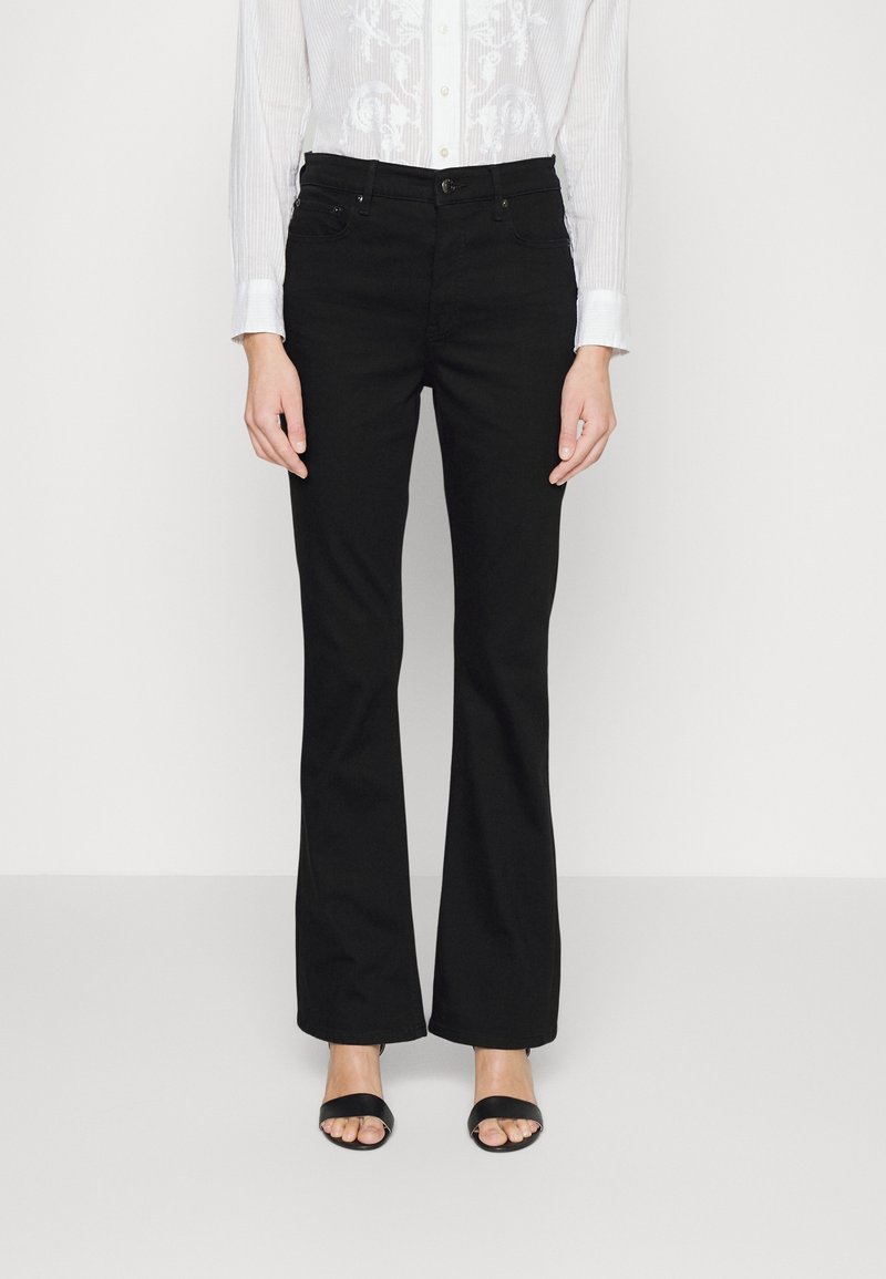 Svarta utsvängda jeans i denim, med en medelhög midja, fem fickor och subtila stickningsdetaljer. Bärs med en vit skjorta.