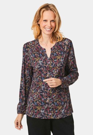Langärmlige Bluse aus einem dunklen Stoff mit buntem Blätterdruck. Verfügt über einen V-Ausschnitt und geraffte Bündchen. Glatte Textur, lässige Passform.