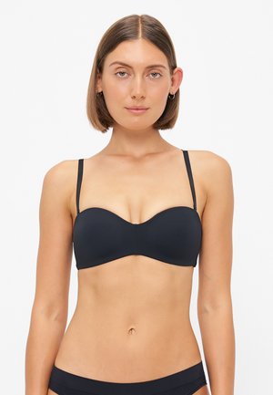 Black padded bra with a smooth texture, thin adjustable straps, and a seamless design. Front features a subtle curved neckline.