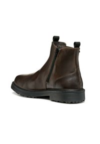 Botas de tobillo de cuero marrón con cremallera lateral, talón reforzado y suela de goma texturizada, que incluyen lengüetas para facilitar el calzado.