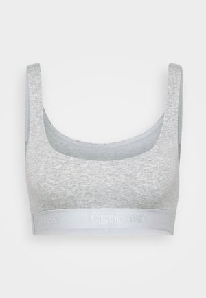 Bralet din bumbac organic gri, cu bretele late, o decolteu în formă de semicerc și un bandaj elastic moale cu logo-ul "Organic Basics" embosat în argintiu.