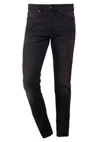 Svarta slim-fit jeans med fram- och bakfickor, bältesöglor och knappstängning, stående på en vit bakgrund.