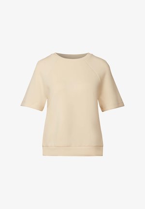 Beige kortærmet top lavet af blødt stof. Har en rund halsudskæring, raglanærmer og en lige kant. Glat, minimalistisk design.
