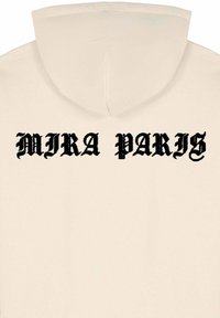 Felpa beige con cappuccio caratterizzata da una scritta in carattere gotico nero che recita "MIRA PARIS" sul retro. Tessuto morbido, design del cappuccio standard.