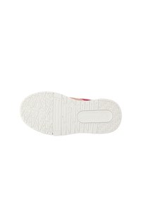 White rubber shoe outsole with textured grip, featuring a wave pattern and logo detail. Sole is flat and slightly raised at the heel.