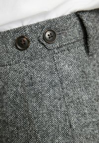 Gray tweed trousers featuring a textured fabric with two black buttons at the waistband and a single front pocket detail.