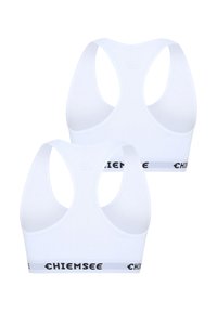 White sports bras with a racerback design. Features a black and gray elastic band with "CHIEMSEE" logo. Smooth fabric texture.
