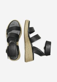 Svarta lädersandaler i espadrille-stil med tre breda remmar, häl i jute som är lindad, och en spänne för ankeln.